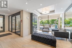 Toronto (Flemingdon Park) condo for rent - A modern living room with a black ottoman and a glass door leading to a balcony.