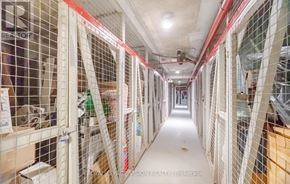 Toronto (Flemingdon Park) condo for rent - A long hallway with white walls and red piping.