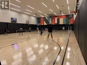 Toronto (Waterfront Communities) condo for rent - A basketball court with people playing and a scoreboard showing 3 points.