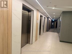 Kitchener condo for rent - A hallway with a sign that says "REALTOR" on the wall.