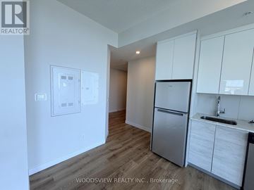 Kitchener condo for rent - A kitchen with white cabinets and a stainless steel refrigerator.