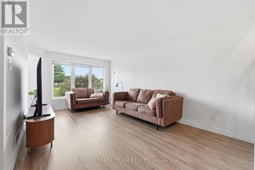 Ottawa townhouse for rent - A living room with a brown sofa and a television.
