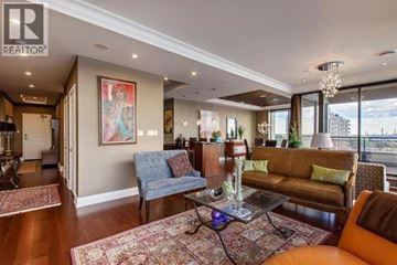 Sarnia condo for rent - A living room with a blue couch and a brown couch.