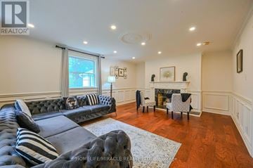 Caledon (Palgrave) apartment for rent - A living room with a black couch and a fireplace.