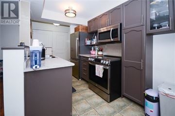 Hamilton apartment for rent - A kitchen with brown cabinets and a black oven.