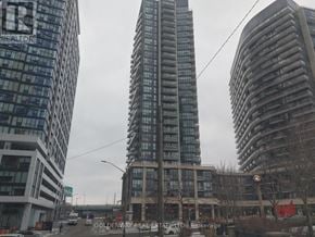 Toronto (Niagara) condo for rent - A tall building with the words "Goldenway Real Estate" on it.