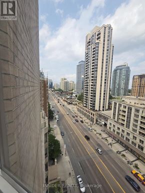 Toronto (Willowdale West) condo for rent - A city street with cars and buildings.