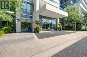 Markham (Grandview) condo for rent - The entrance to a building with a glass door and a sign that reads "165".