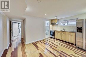 Toronto (Alderwood) apartment for rent - A kitchen with wooden flooring and white walls.