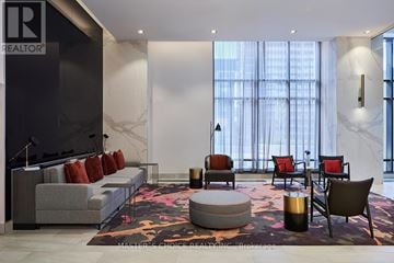 Toronto (Islington-City Centre West) condo for rent - A living room with a grey sofa and a round ottoman.