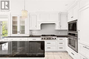 Burlington apartment for rent - A modern kitchen with white cabinets and a black countertop.