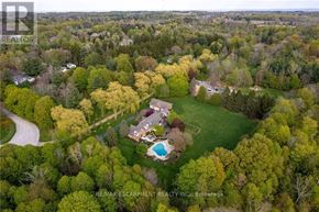 Burlington apartment for rent - A bird's eye view of a house surrounded by a green lawn and trees.