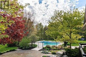 Burlington apartment for rent - A pool surrounded by trees and a fence.