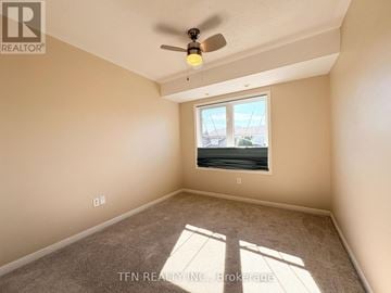 Mississauga (Cooksville) townhouse for rent - A room with a ceiling fan and a window letting in sunlight.