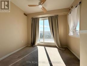 Mississauga (Cooksville) townhouse for rent - A room with a ceiling fan and a view of a balcony.