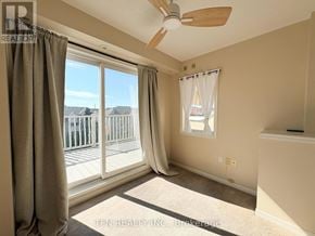 Mississauga (Cooksville) townhouse for rent - A room with a fan, carpet, and a window with curtains.