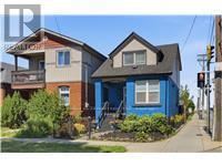 Hamilton (Homeside) apartment for rent - A blue house with a white window and a brown roof.