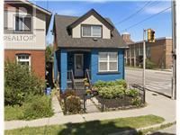 Hamilton (Homeside) apartment for rent - A blue house with a brown roof and a sign that says REALTOR.