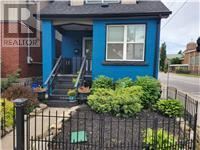Hamilton (Homeside) apartment for rent - A blue house with a black fence in front.