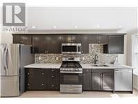 Hamilton (Homeside) apartment for rent - A modern kitchen with dark brown cabinets and stainless steel appliances.