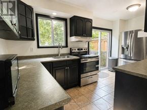 London North (North I) apartment for rent - A kitchen with black cabinets and stainless steel appliances.