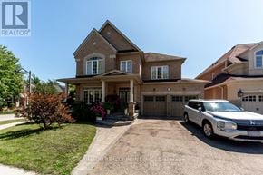 Pickering (Brock Ridge) apartment for rent - A large house with a white car parked in front.