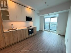Vaughan (Vaughan Corporate Centre) condo for rent - A kitchen with wooden cabinets and a sink.