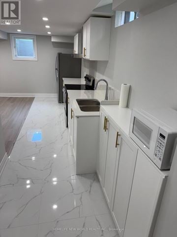 Richmond Hill (Devonsleigh) apartment for rent - A kitchen with white cabinets and a marble floor.