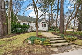 Burlington (Roseland) apartment for rent - A white house with a green roof is surrounded by trees.