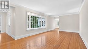 Burlington (Roseland) apartment for rent - A room with wooden floors and a window with a view of trees.