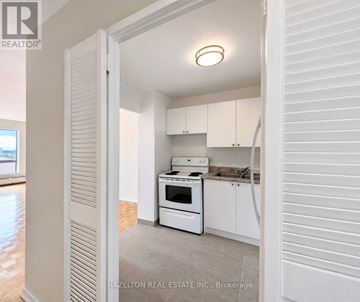Mississauga (Applewood) condo for rent - A kitchen with white cabinets and a stove top oven.
