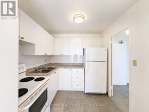Mississauga (Applewood) condo for rent - A kitchen with white appliances and cabinets.