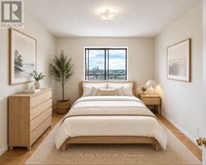 Mississauga (Applewood) condo for rent - A bedroom with a large bed, a dresser, and a window overlooking a cityscape.