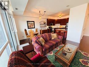 Mississauga (Port Credit) condo for rent - A living room with a couch, chairs, and a coffee table.