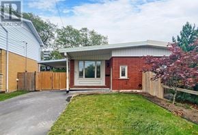 Hamilton (Lawfield) apartment for rent - A red brick house with a white door and a brown fence.