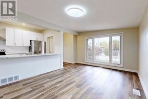 Hamilton (Lawfield) apartment for rent - A well-lit, empty room with wooden flooring and a large window.