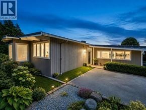 West Vancouver apartment for rent - A house with a grey exterior and a gravel path leading to the front door.