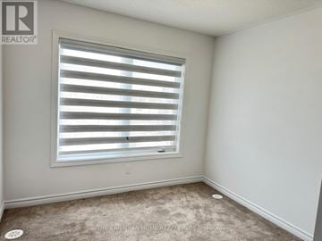 Caledon townhouse for rent - A room with a window covered by white blinds.
