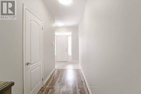 Hamilton (Stoney Creek Mountain) townhouse for rent - A long hallway with white walls and wood floors.