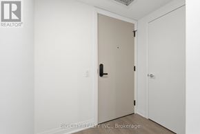 Toronto (Leaside) condo for rent - A white door with a black handle is in a room with white walls.