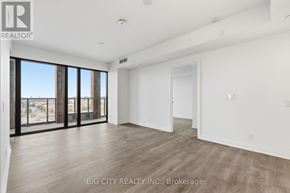 Toronto (Leaside) condo for rent - A spacious room with a view of the city through large windows.