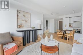 Toronto (Thorncliffe Park) condo for rent - A living room with a brown couch and a coffee table in the middle.