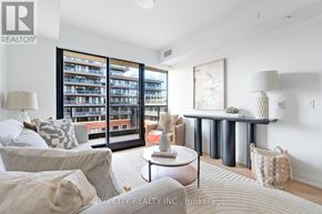 Toronto (Thorncliffe Park) condo for rent - A living room with a couch, a coffee table, and a large window with a view of a building.