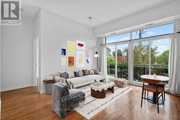 Ottawa condo for rent - A living room with a white couch, a coffee table, and a painting on the wall.