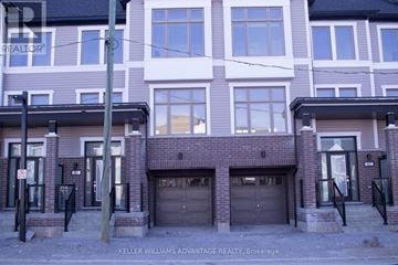 New Tecumseth (Tottenham) townhouse for rent - A building with a sign that says Keller Williams Advantage Realty.