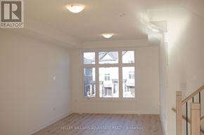 New Tecumseth (Tottenham) townhouse for rent - A room with a window and a wooden floor.