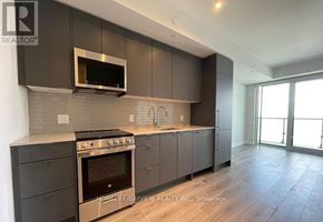 Mississauga (Creditview) condo for rent - A modern kitchen with dark brown cabinets and stainless steel appliances.