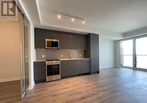 Mississauga (Creditview) condo for rent - A modern kitchen with dark wood cabinets and a brick backsplash.