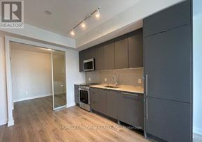 Mississauga (Creditview) condo for rent - A modern kitchen with dark brown cabinets and a wooden floor.