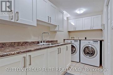 Mississauga (Central Erin Mills) apartment for rent - A kitchen with white cabinets and a granite countertop.